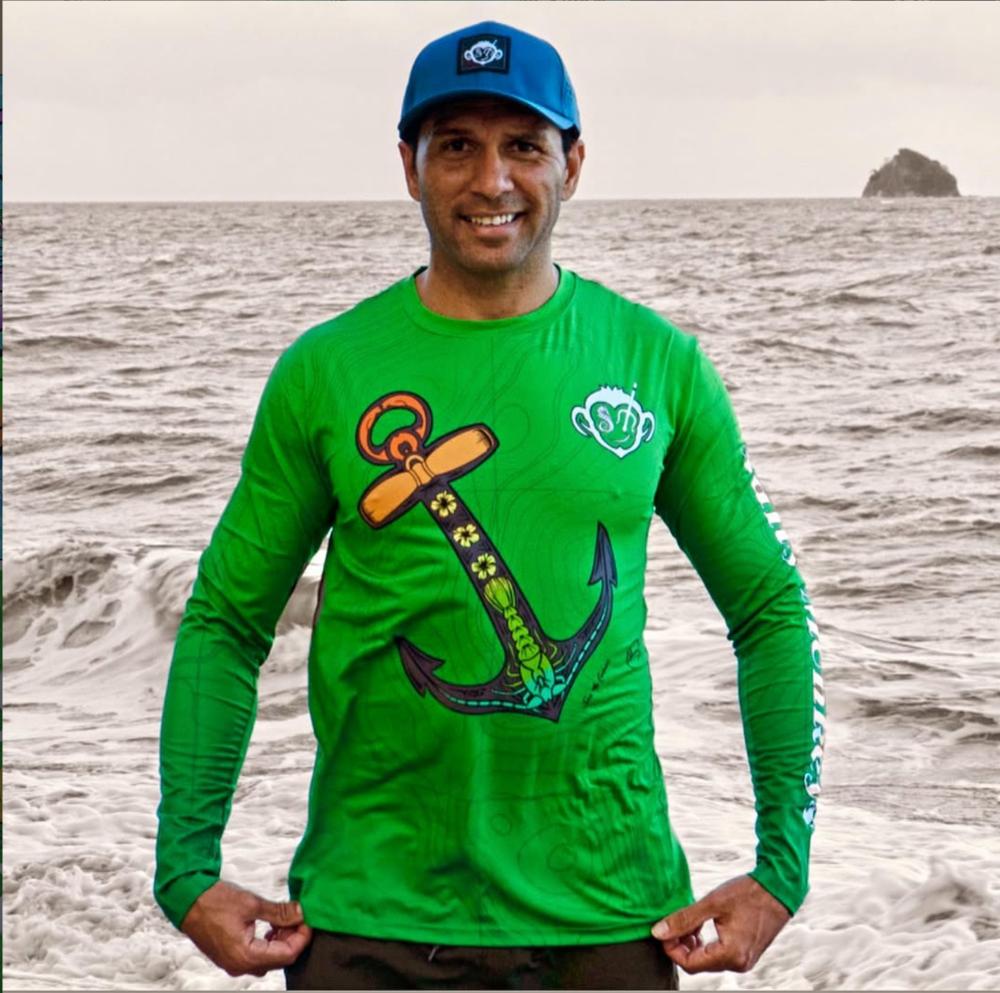 The Anchor design on a green shirt at the beach.