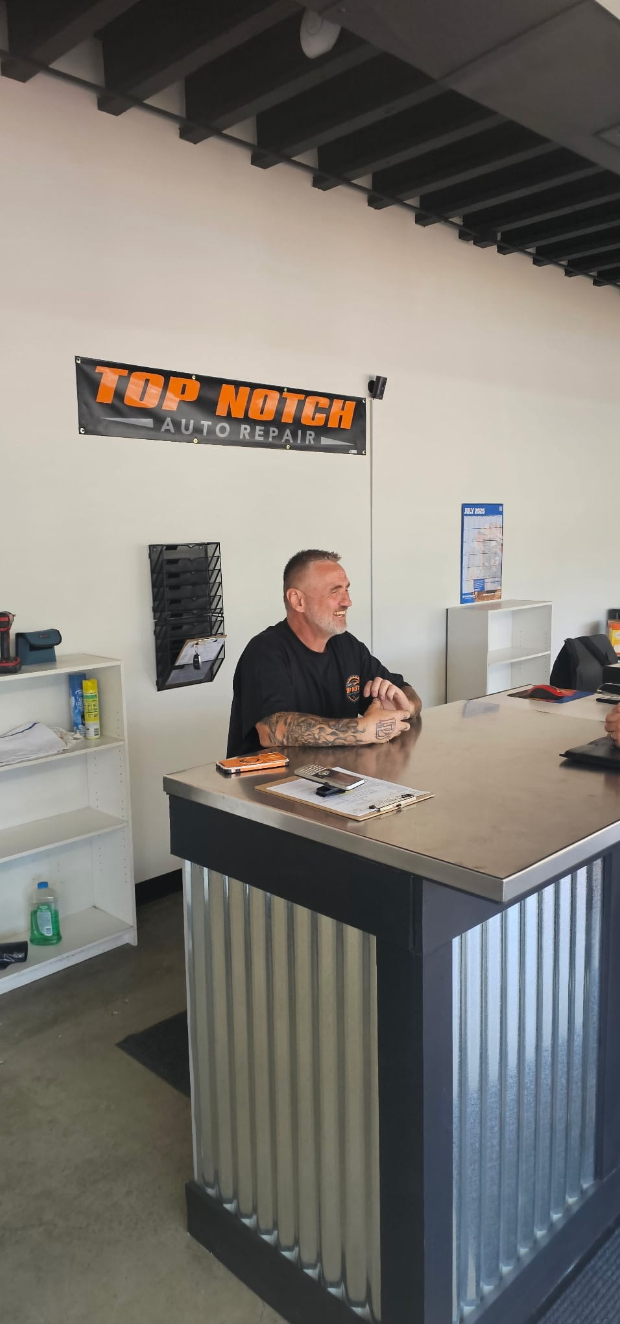 Smiling Top Notch Auto Repair advisor at the front counter in Vancouver WA