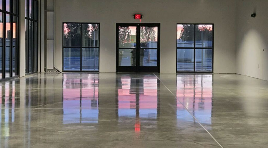 Polished commercial floor with high-gloss reflective finish and glass entrance doors