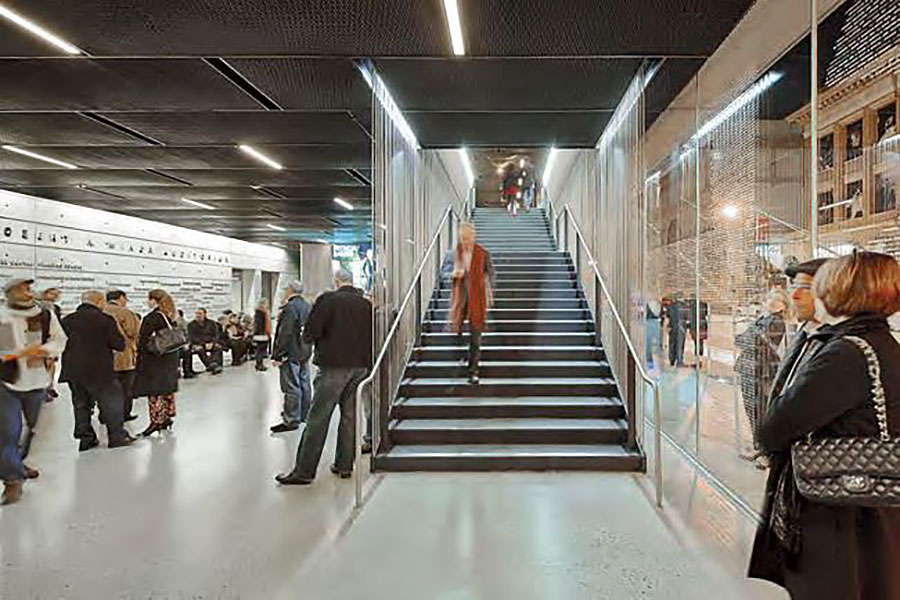 High-traffic public interior with polished floor, staircase and visitors in a modern building