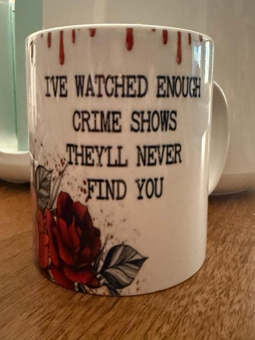 Back view of a white 12oz mug with red dripping accents, quote lettering, and a red rose design