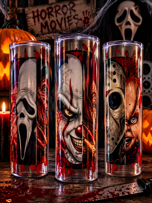 Three horror-themed tumblers featuring a ghost mask, clown, and hockey mask in a dark Halloween display with pumpkins, a horror movie sign, and a masked figure