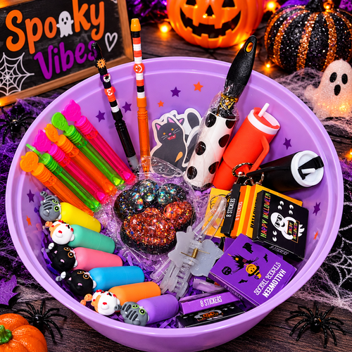 Halloween goodie bag assortment with colorful toys, treats, and stickers in a purple bowl