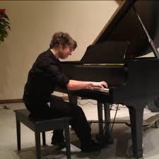 Pianist playing a grand piano