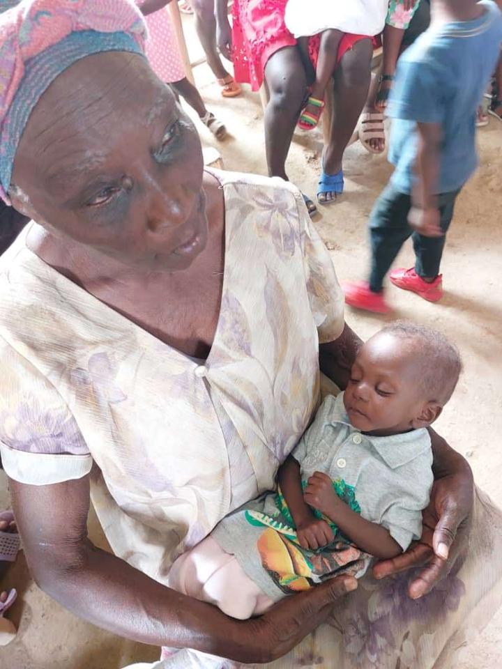 A caregiver holding a baby during community care