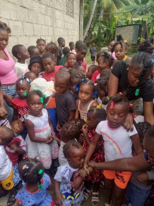 Children gather during community outreach in Haiti