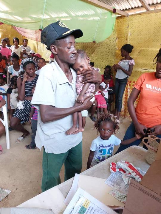 A family receives meal support during outreach in Haiti