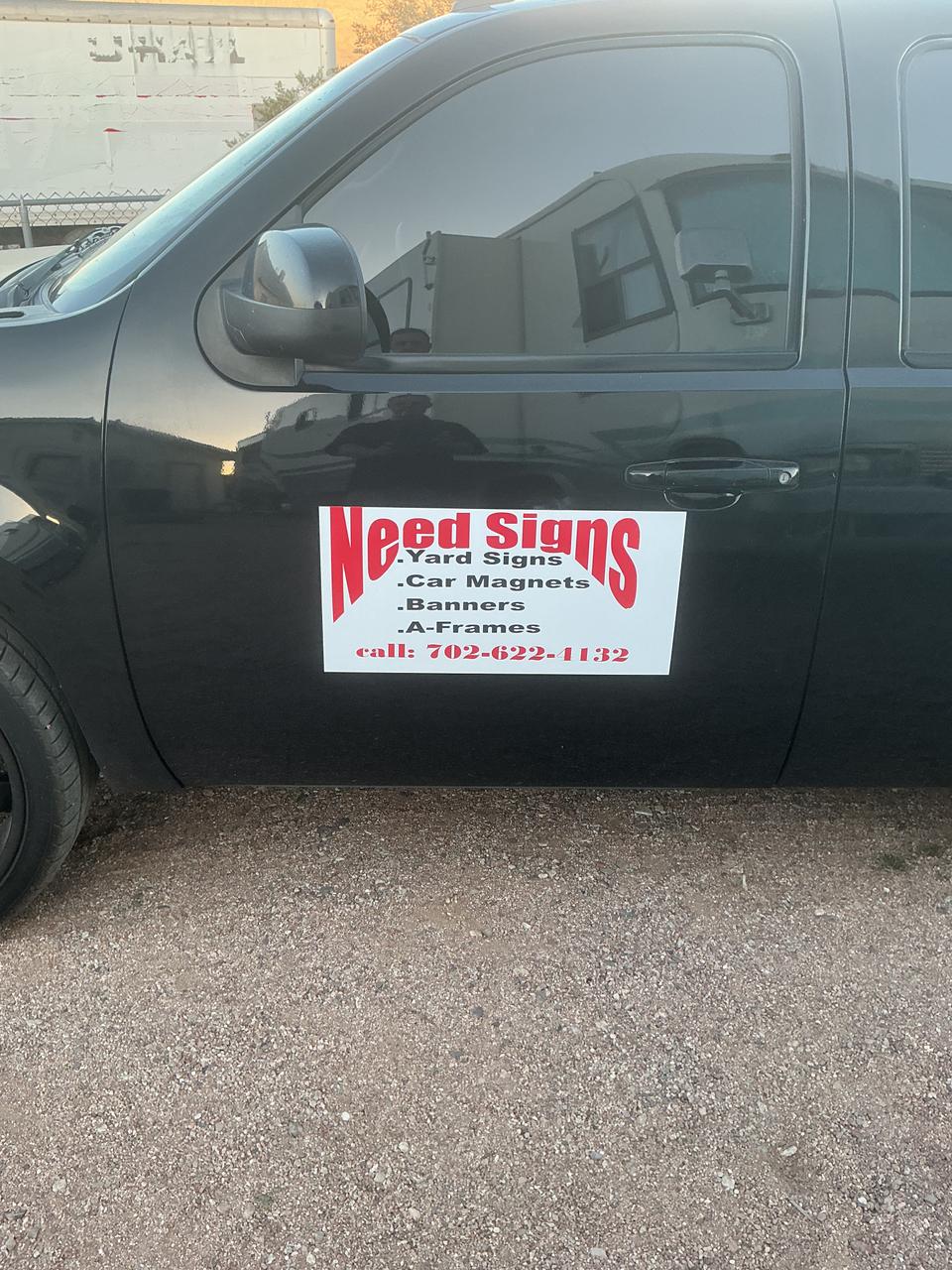 White door magnet listing sign, yard sign, car magnet, banner, and A-frame services on a dark vehicle.