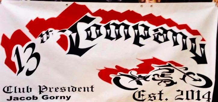 White motorcycle-club banner with a red mountain design, ornate black lettering, a motorcycle graphic, and member details.