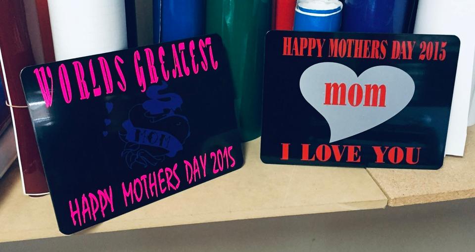 Two dark signs for Mother's Day 2015, one with a bright pink personal message and one reading Happy Mother's Day 2015, Mom, I Love You.