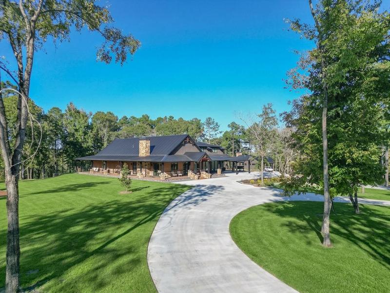 Single-story home with a curved driveway and landscaped lawn.