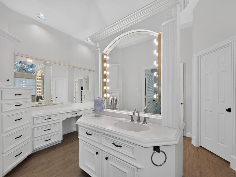 Bright bathroom vanity with double sinks and large mirrors.