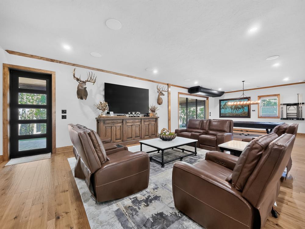 Game room with leather seating and a billiards table.