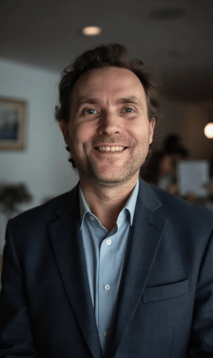Frank Svendsen smiling in business attire