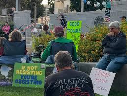Community members gathered at a civic rally with democracy signs