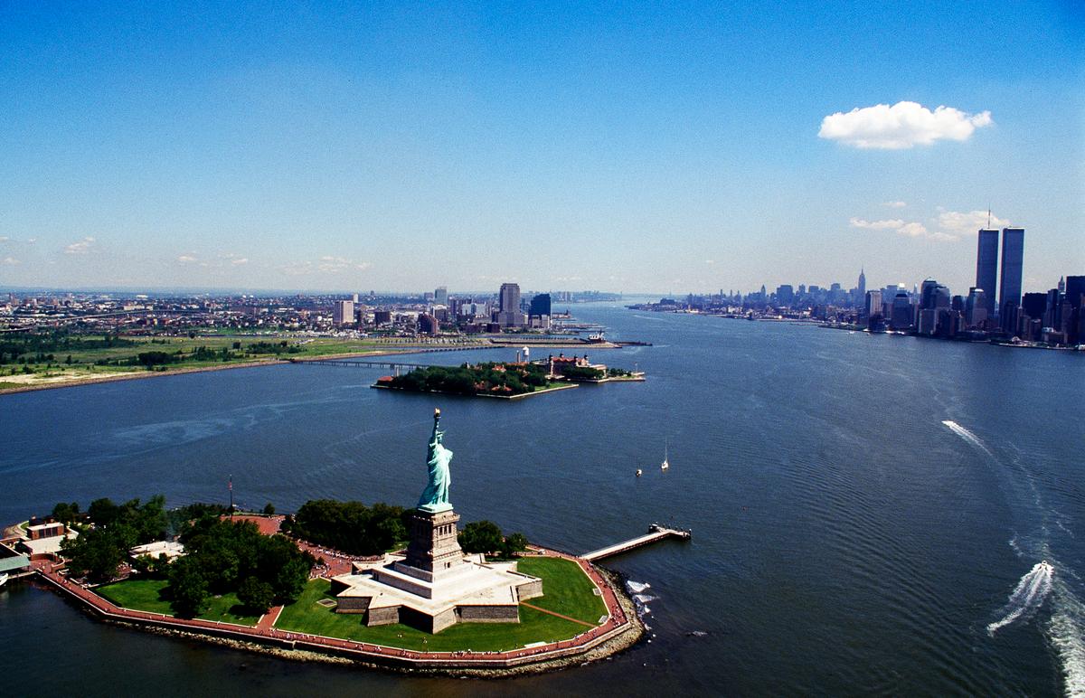 Historic view of the Statue of Liberty and the Twin Towers across New York Harbor.